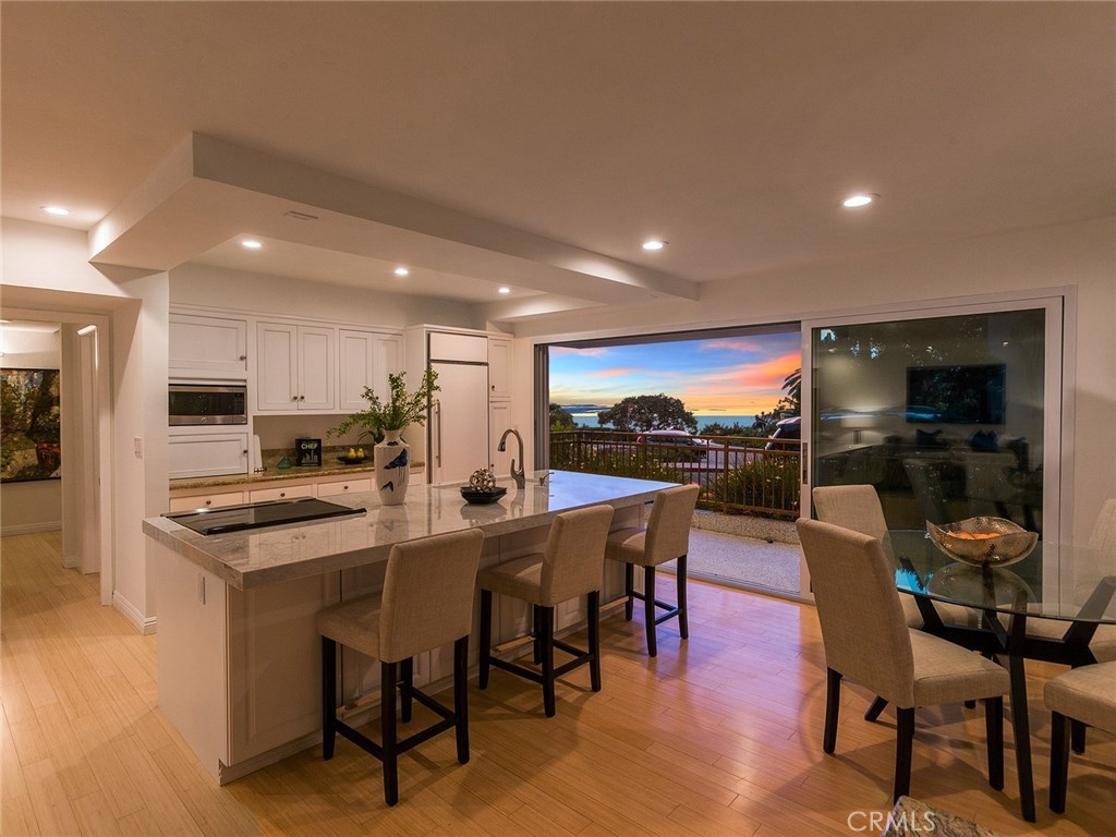 Kitchen and dining room at sunset. - 496 Cliff Drive 3, Laguna Beach CA 92651 - photo 1
