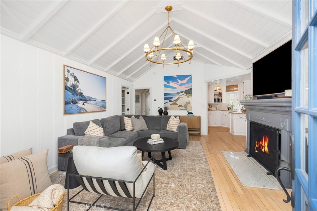 Charming living room with a working fireplace(virtually altered for picture). - 501 Lombardy Lane, Laguna Beach CA 92651 - photo 4