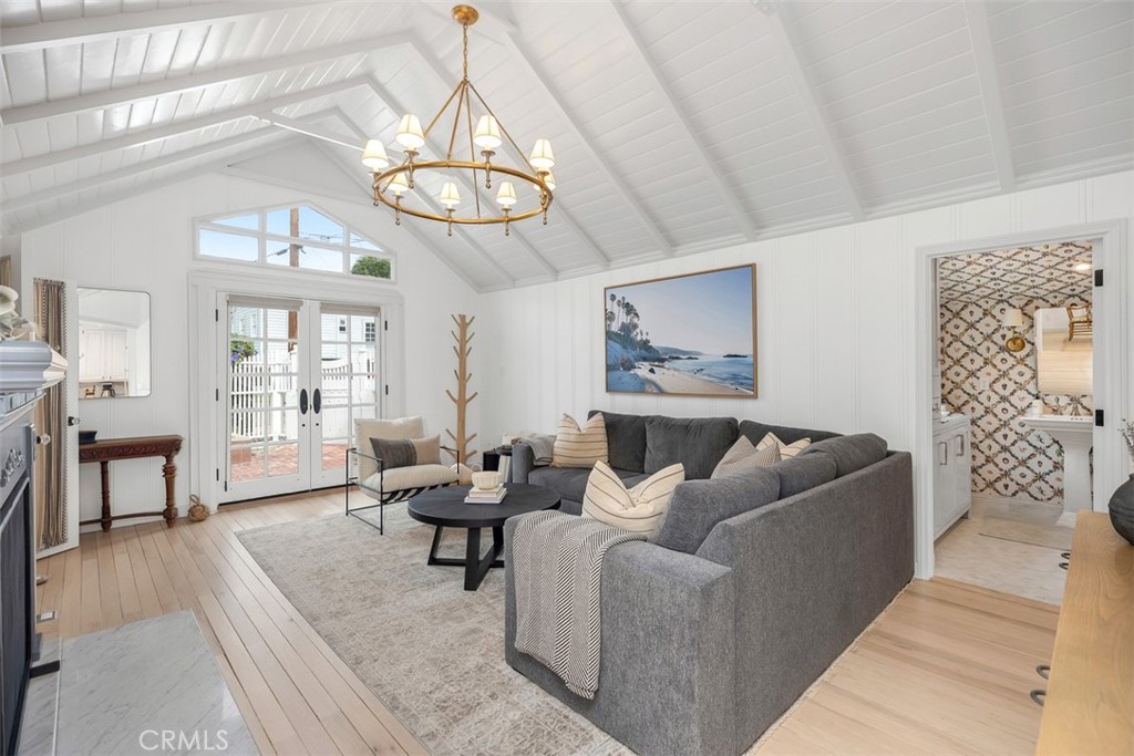 White oak flooring throughout home and Ralph Lauren chandelier focal point in living room. - 501 Lombardy Lane, Laguna Beach CA 92651 - photo 6
