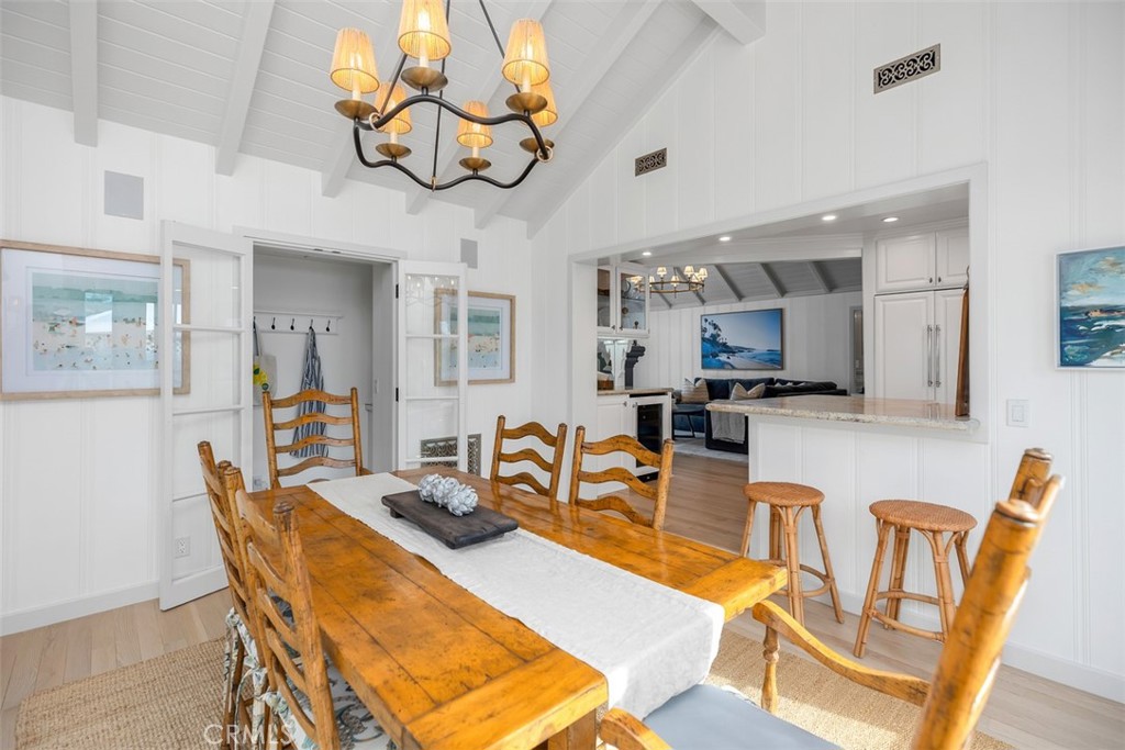 Another view of the dining room space with laundry room nearby and looking into the living room and kitchen. - 501 Lombardy Lane, Laguna Beach CA 92651 - photo 14