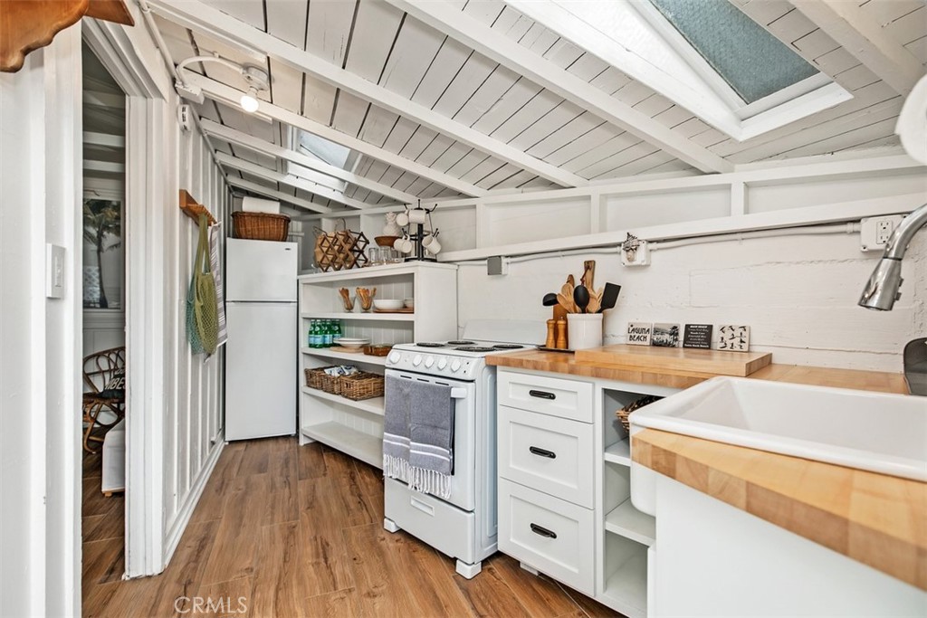 Kitchenette with range , refrigerator, and butcher block wood counters. - 509 Diamond Street, Laguna Beach CA 92651 - photo 8