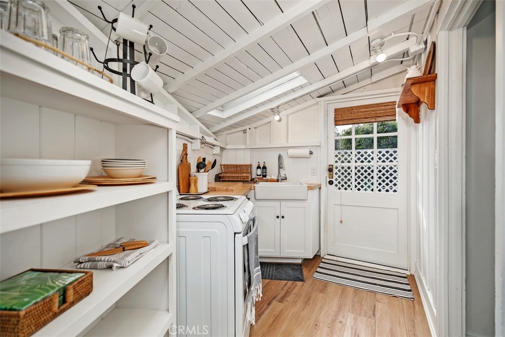 The kitchenette has a door leading outside to the side patio. - 509 Diamond Street, Laguna Beach CA 92651 - photo 9