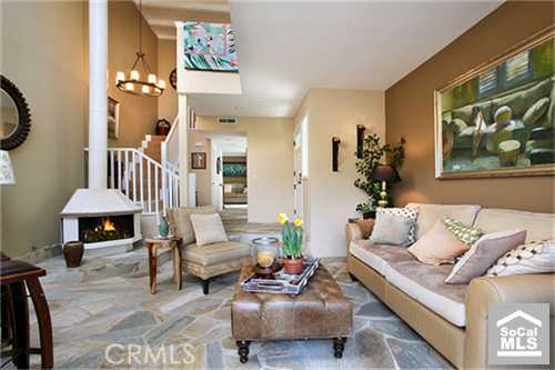 Living room with with continuous slate flooring onto front patio. - 552 Cypress Drive B, Laguna Beach CA 92651 - photo 1