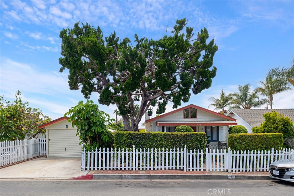 Street view with garage on left, a driveway is important to have in this neighborhood. The large juniper has been profes - 555 Through Street, Laguna Beach CA 92651 - photo 1
