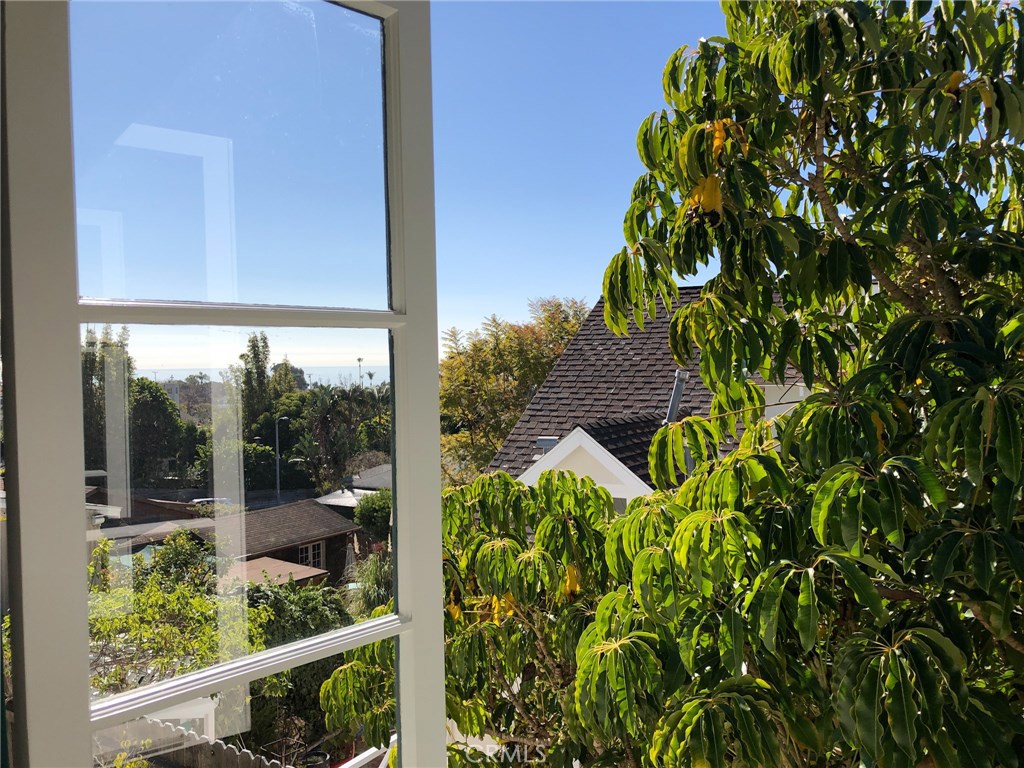 Enjoy an ocean view and picturesque greenery. The trees will be trimmed to grant a more extensive ocean view. - 571 Blumont Street, Laguna Beach CA 92651 - photo 1