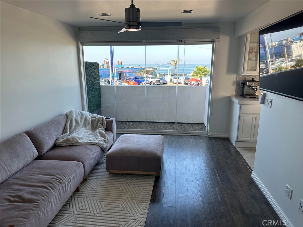 Living room has modern, retractable floor-ceiling glass doors to private balcony - 577 Ramona A, Laguna Beach CA 92651 - photo 9