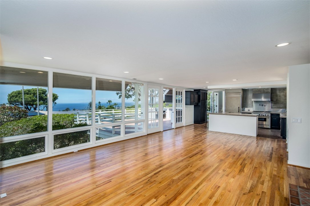 Spacious living room with newly refinished wood floors flowing out to the deck with ocean views. - 590 Diamond Street, Laguna Beach CA 92651 - photo 1