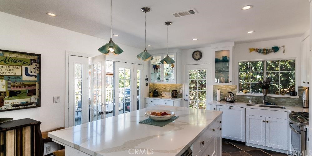 The upper cottage features a state of the art kitchen with a gas range, ample counter space, wine refrigerator, center i - 635 Saint Anns Drive, Laguna Beach CA 92651 - photo 1