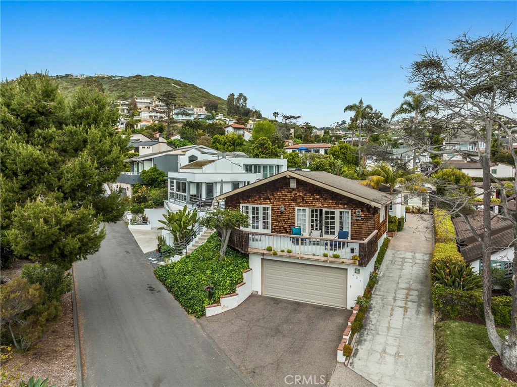 Approximately 1,944 square feet, the shingled cottage-inspired home hosts a two-car garage, long driveway, a private bri - 637 Virginia Park Drive, Laguna Beach CA 92651 - photo 1