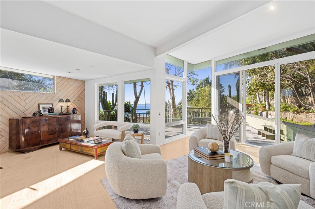 High ceilings, abundant natural light, and an open floor plan define the interior, flowing seamlessly to multiple outdoo - 660 Virginia Park, Laguna Beach CA 92651 - photo 3