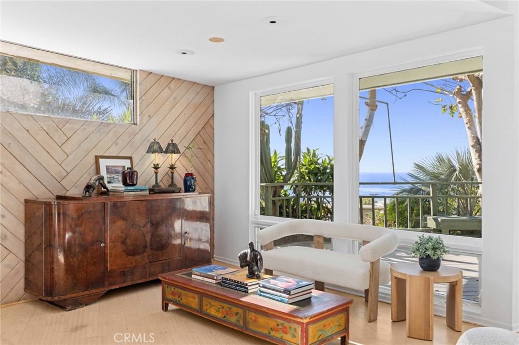 The main living room serves as the showpiece of the home, wrapped in glass to frame sweeping ocean vistas and opening to - 660 Virginia Park, Laguna Beach CA 92651 - photo 9