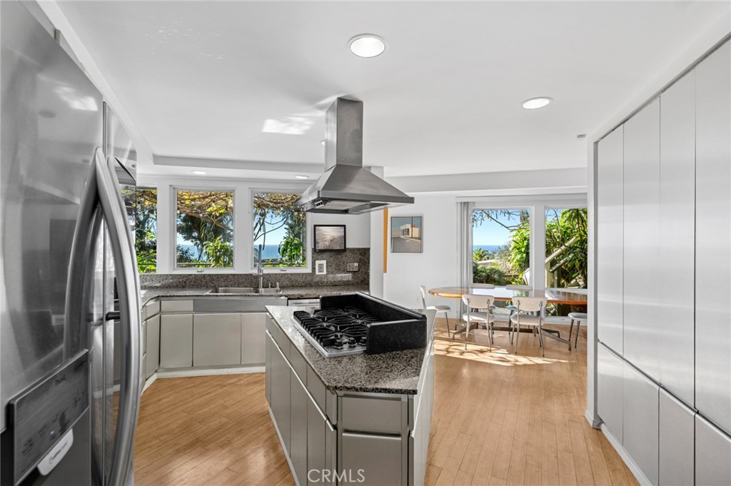 The generous kitchen captures breathtaking ocean and Catalina Island views and flows into the dining area, creating an i - 660 Virginia Park, Laguna Beach CA 92651 - photo 14