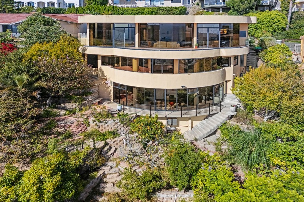 Walls of glass encircle the house on all levels, this home is very visible on the front row of Mystic Hills when looking - 664 Mystic View, Laguna Beach CA 92651 - photo 2