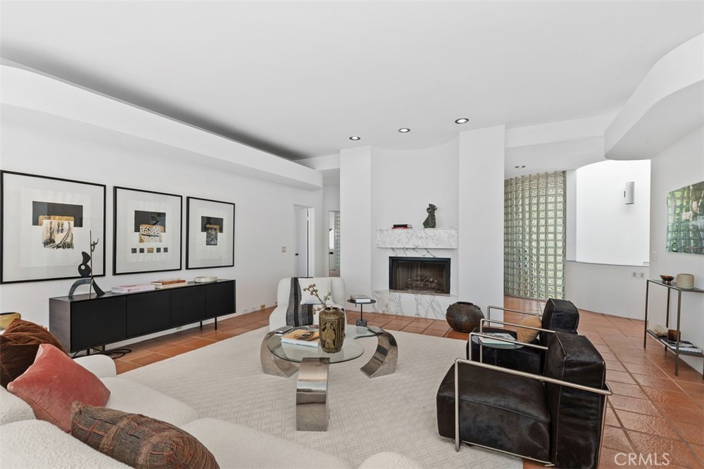 Living room has a centered marble fireplace. - 664 Mystic View, Laguna Beach CA 92651 - photo 19
