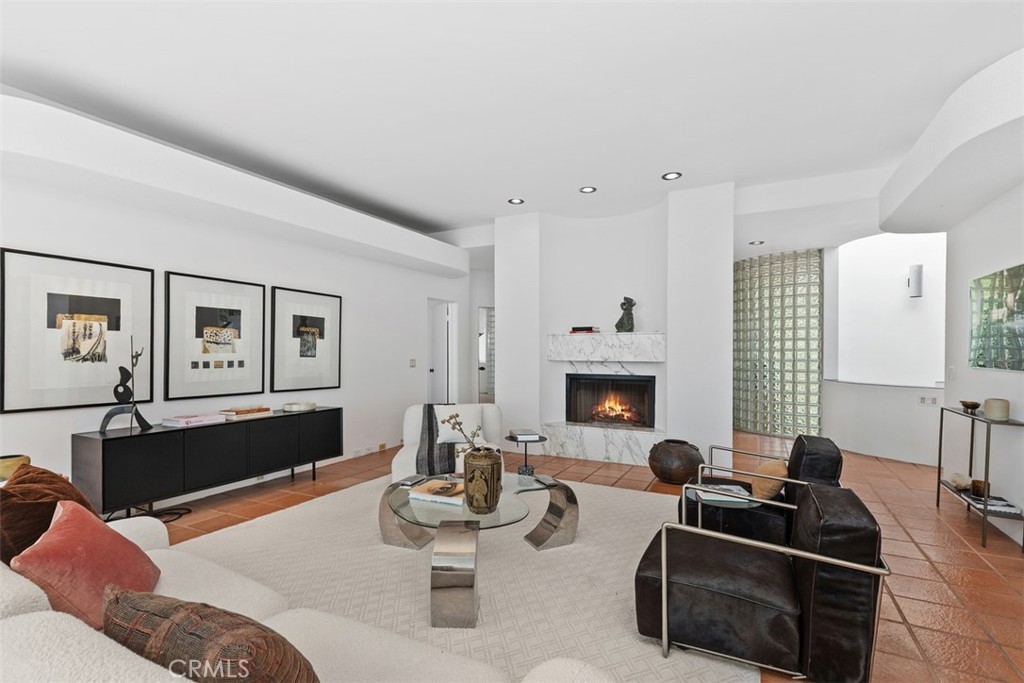 Living room with foyer behind fireplace, glass block walls are found in some spaces throughout the house. - 664 Mystic View, Laguna Beach CA 92651 - photo 20