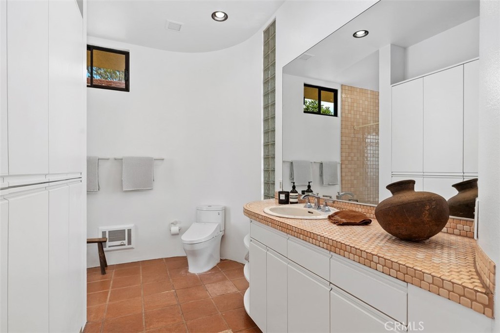 Primary bathroom is ensuite, has many cabinets for storage. - 664 Mystic View, Laguna Beach CA 92651 - photo 33