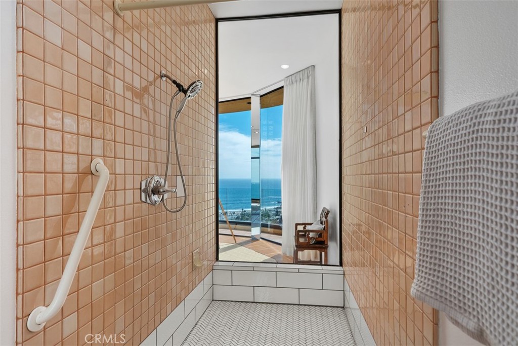 Primary bathroom has large shower, looks out towards view, has recently retiled base. - 664 Mystic View, Laguna Beach CA 92651 - photo 34