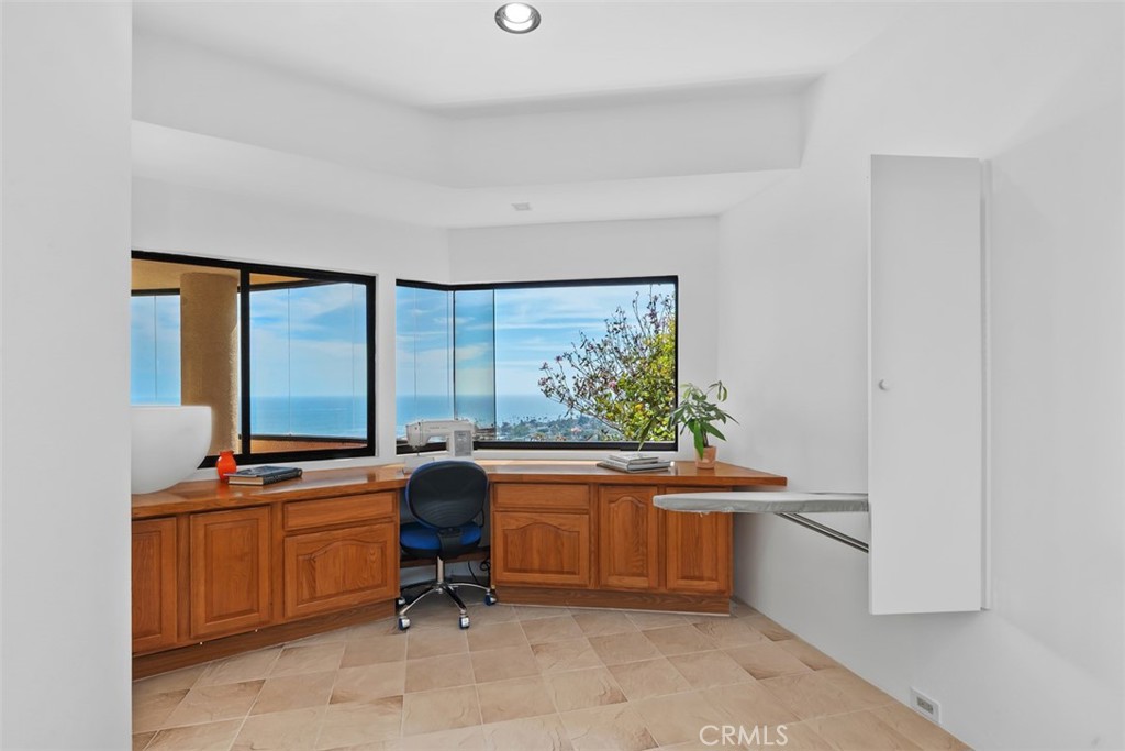 Second level possible 3rd bedroom or craft room shown with sewing machine builtin cabinetry and attached ironing board. - 664 Mystic View, Laguna Beach CA 92651 - photo 45