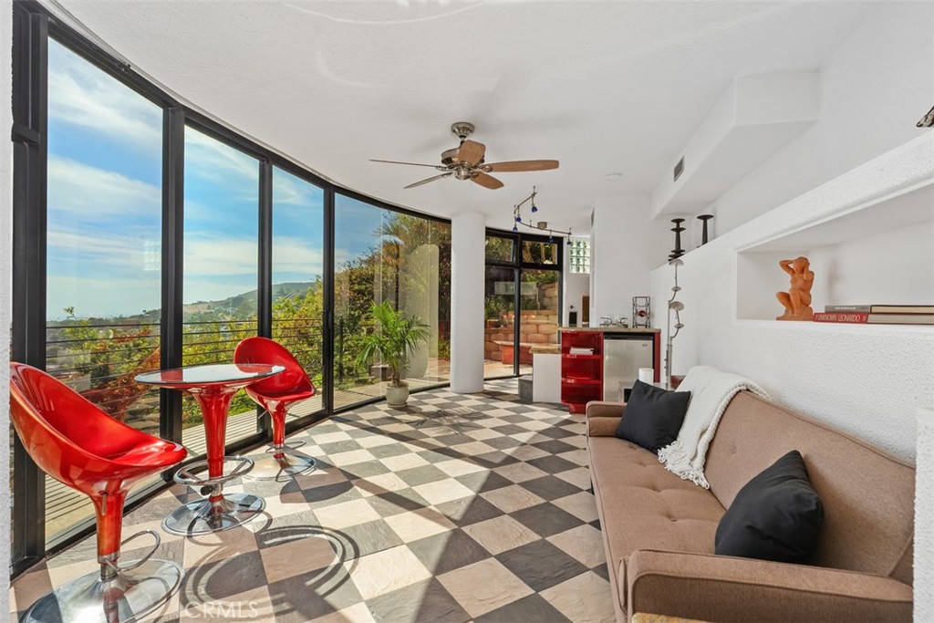Third level guest quarters has living room with walls of glass to enjoy the views, mini refrigerator, kitchenette. - 664 Mystic View, Laguna Beach CA 92651 - photo 47