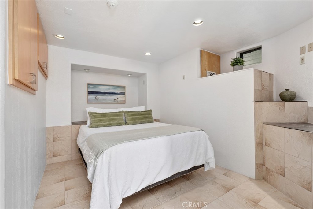 Bedroom in guest quarters has cabinets, window to right, with ensuite bathroom. - 664 Mystic View, Laguna Beach CA 92651 - photo 51