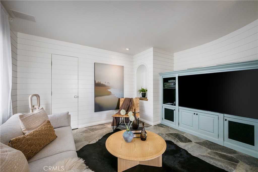 Sitting room adjacent to the living room with a powder bath beyond - 675 Cliff Drive, Laguna Beach CA 92651 - photo 12