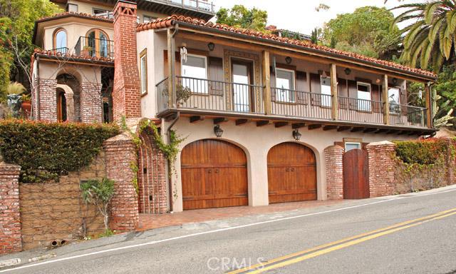 Original balcony, circa 1930, restored with custom wrought iron railing & terra cotta flooring. Garage doors are custom - 710 Summit Drive, Laguna Beach CA 92651 - photo 1