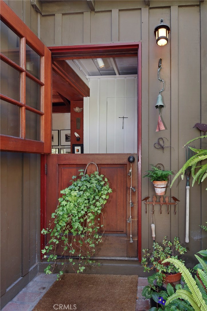 Enter the cottage through the inviting Dutch door to an open and charming living room. - 740 Browncroft Road, Laguna Beach CA 92651 - photo 1
