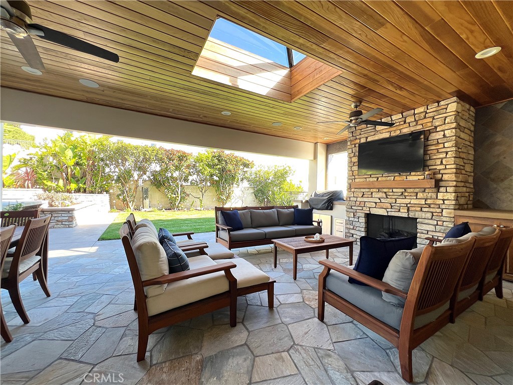 Spacious loggia with large grass area, just off the kitchen complete with grill, fireplace and TV. - 750 Bolsana Drive, Laguna Beach CA 92651 - photo 9