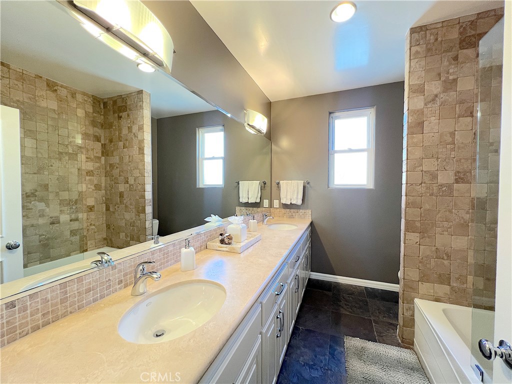 Spacious hallway bathroom between bedroom 3 and 4, with double sinks, tub and shower. - 750 Bolsana Drive, Laguna Beach CA 92651 - photo 48
