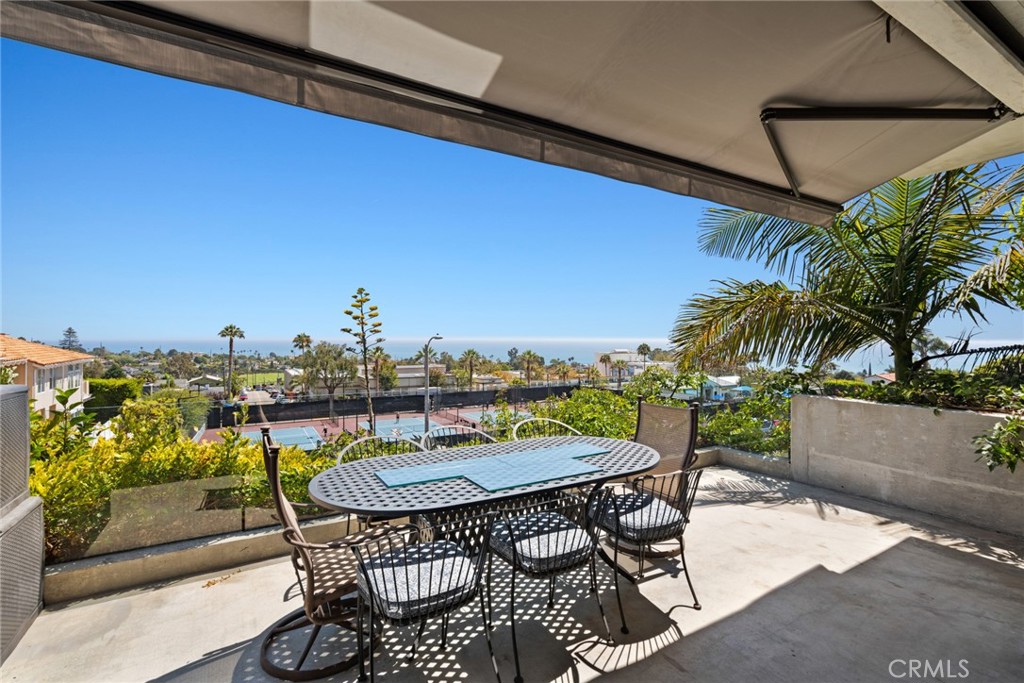 Dine al fresco on the ocean view deck adjoining the living room. - 816 Manzanita, Laguna Beach CA 92651 - photo 1