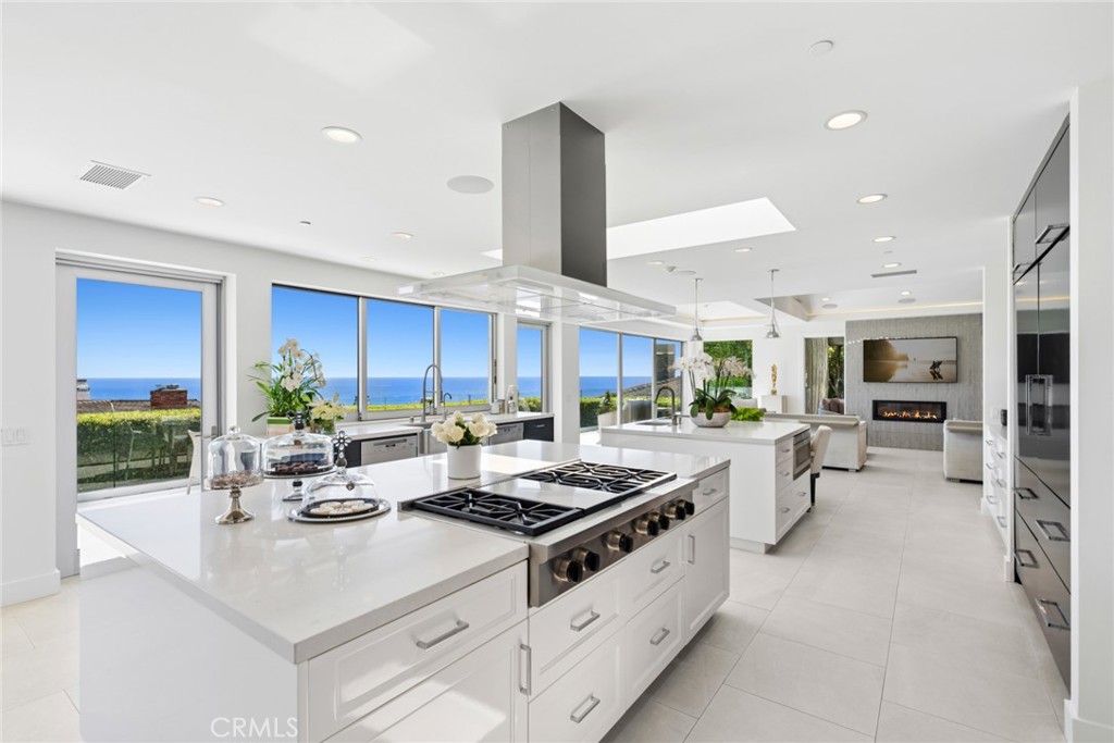 The chef’s kitchen is centered around two oversized islands positioned to capture the ocean views and is complemented by - 820 Emerald Bay, Laguna Beach CA 92651 - photo 2