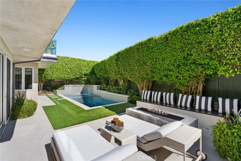 The lower level opens directly to a completely private outdoor setting featuring a generous yard, resort-inspired pool a - 820 Emerald Bay, Laguna Beach CA 92651 - photo 4