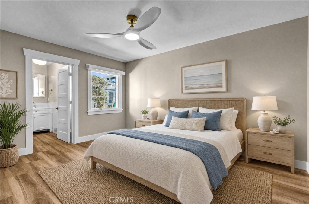 AI-Staged Bedroom | Bright bedroom with en-suite bath, built-out closets, extra natural light, and TV wall mount. - 826 S Coast A, Laguna Beach CA 92651 - photo 8