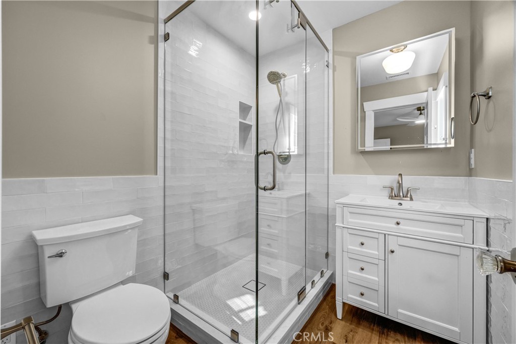 Bathroom | Custom finishes, spacious tiled shower, stylish tile pony wall, and a modern lighted mirror. - 826 S Coast A, Laguna Beach CA 92651 - photo 10