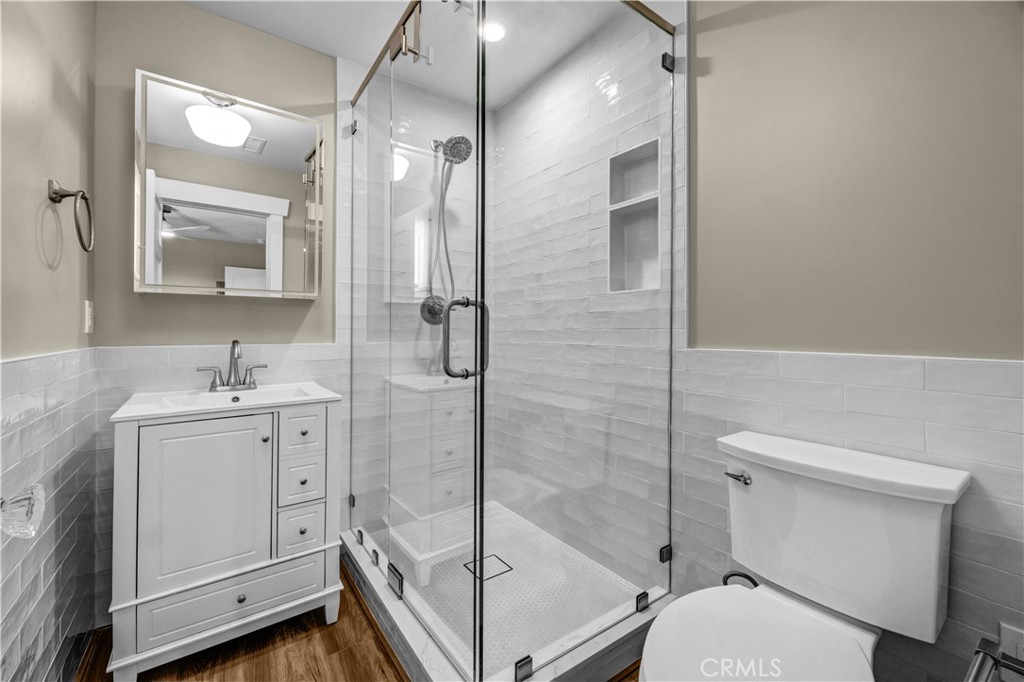 Bathroom | Custom finishes, spacious tiled shower, stylish tile pony wall, and a modern lighted mirror. - 826 S Coast B, Laguna Beach CA 92651 - photo 11