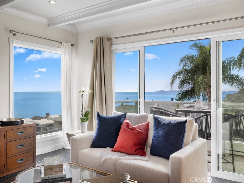Open floorplan flows freely to a sunny deck with panoramic ocean views, providing a scenic setting for gatherings with f - 882 Acapulco Street, Laguna Beach CA 92651 - photo 1