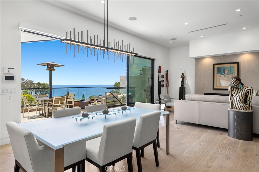 The main level inspires chic entertaining with stunning ocean views that are framed by walls of glass in an open-concept - 909 Summit Way, Laguna Beach CA 92651 - photo 1