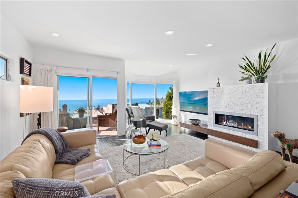 Natural light brightens the open floorplan’s stunning interiors, which include a living room with linear fireplace. - 928 Quivera, Laguna Beach CA 92651 - photo 1