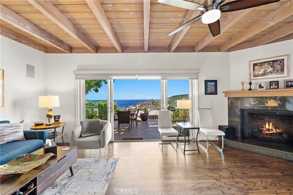 Living room with vaulted ceilings and fireplace - 930 Canyon View Drive, Laguna Beach CA 92651 - photo 11