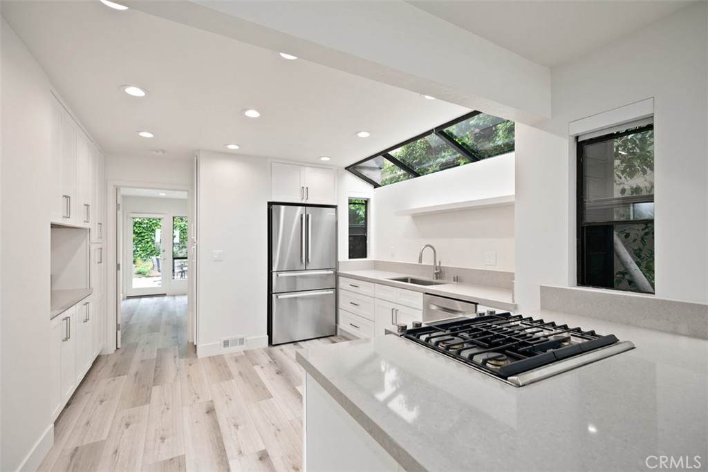 Brand new kitchen featuring a Bosch refrigerator and dishwasher along with a Jenn Air gas stove. - 934 Quivera Street, Laguna Beach CA 92651 - photo 1