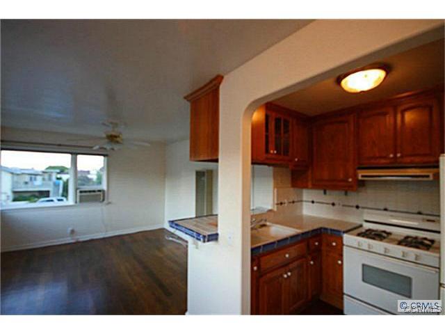 Kitchen open to living room with ceiling fan and window AC unit~ - 987 Glenneyre Street, Laguna Beach CA 92651 - photo 1