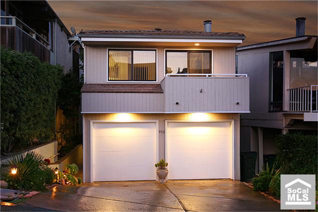 Exterior front of home. Flowering landscaping on sprinkler and drip systems. Two car garage and two car driveway parking - 992 NORIA Street, Laguna Beach CA 92651 - photo 1