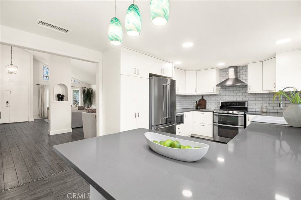Pendant lights & stainless steal hood only enhance the kitchen even more - 25182 Stockport, Laguna Hills CA 92653 - photo 15