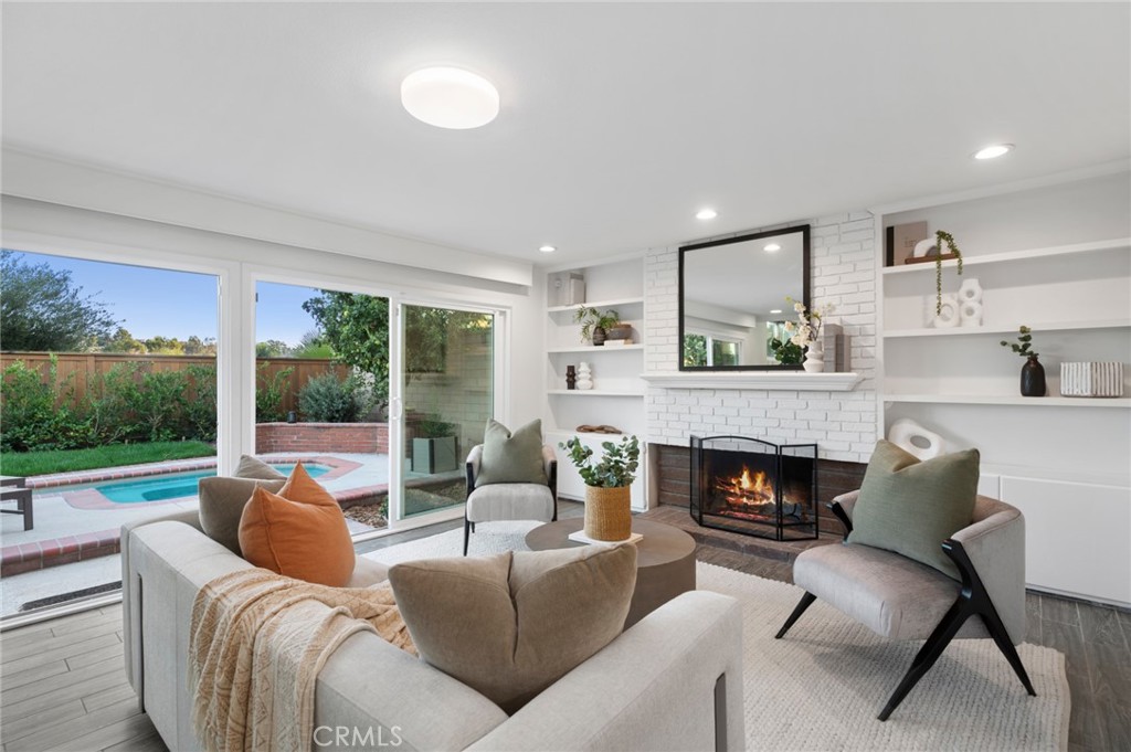 The adjoining family room provides a warm gathering space w/a fireplace perfect for relaxed evenings - 25182 Stockport, Laguna Hills CA 92653 - photo 18