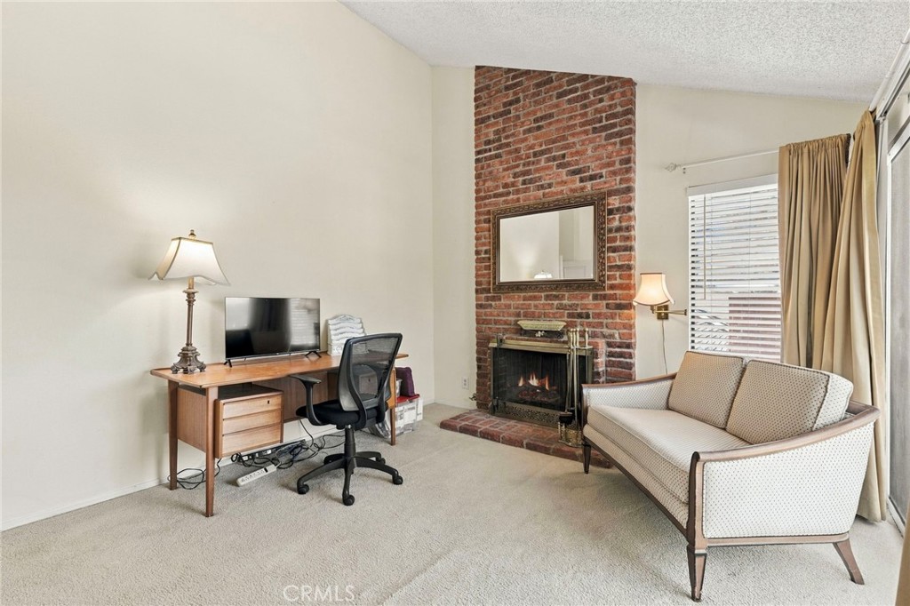 Primary bedroom sitting area with fireplace - 25516 La Mirada Street, Laguna Hills CA 92653 - photo 28