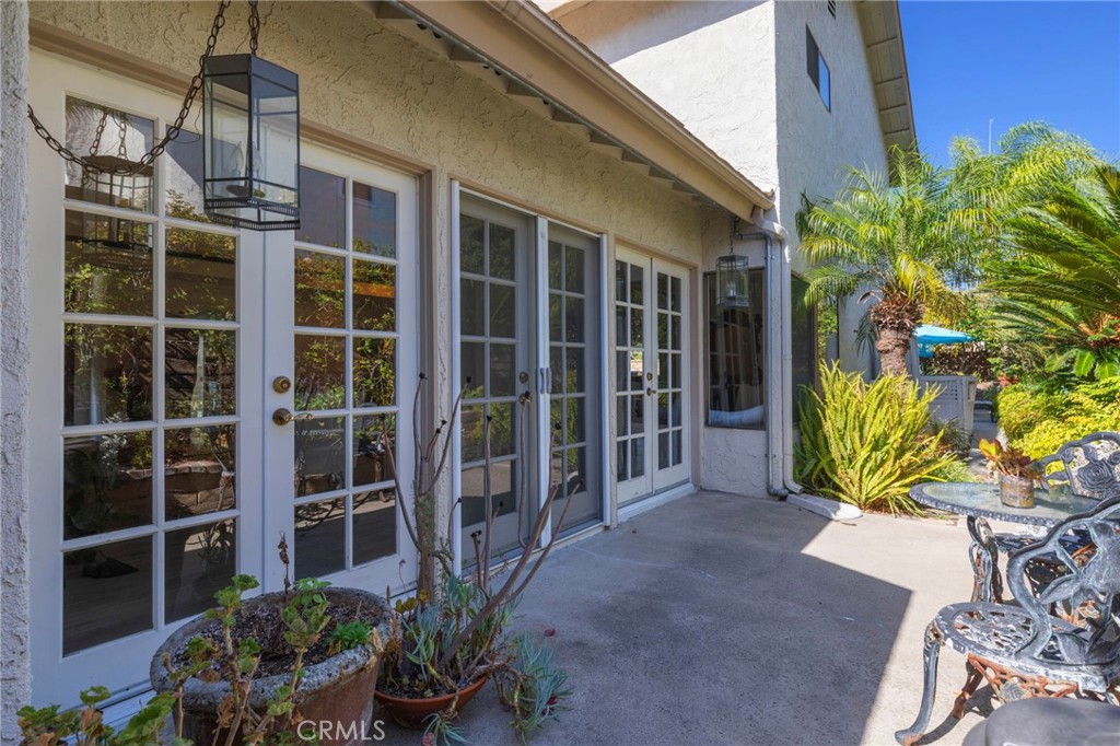 French doors off of living room to side patio area - 25516 La Mirada Street, Laguna Hills CA 92653 - photo 48