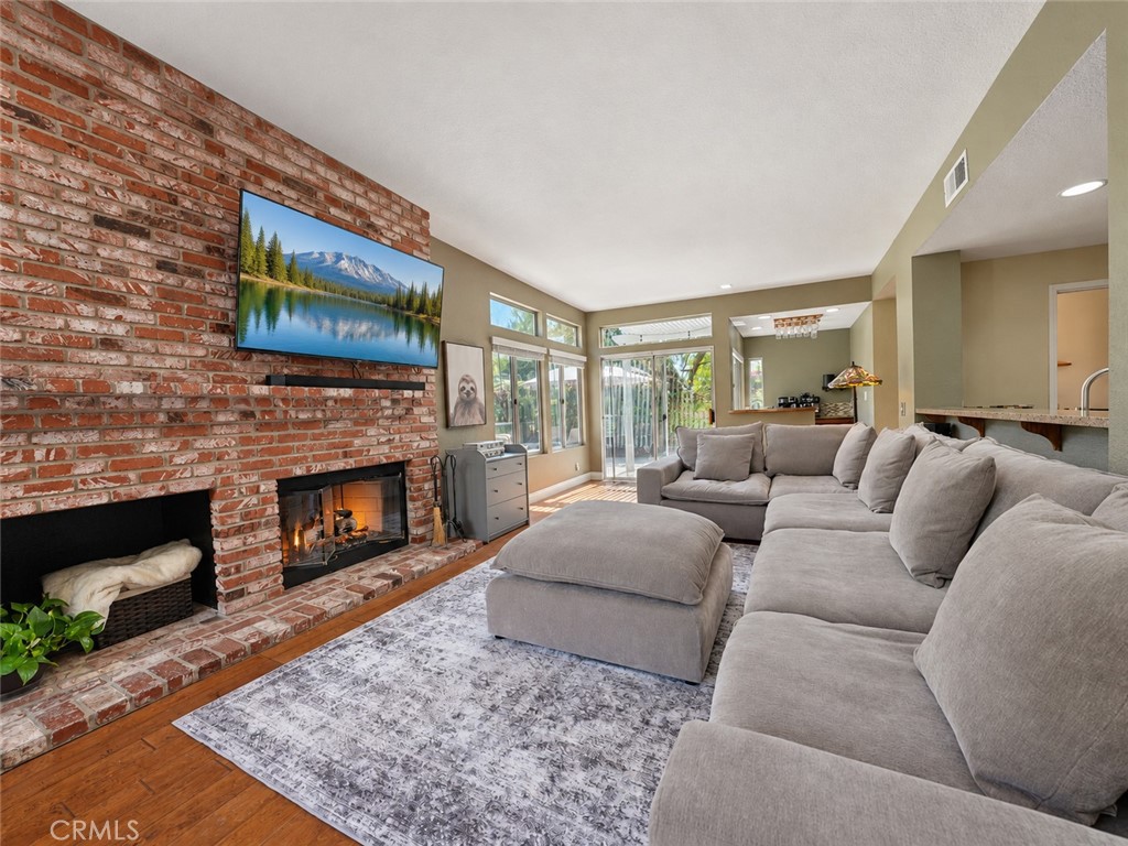 Enjoy gatherings in the generously-sized living area graced by a fireplace - 25652 Nottingham Court, Laguna Hills CA 92653 - photo 3