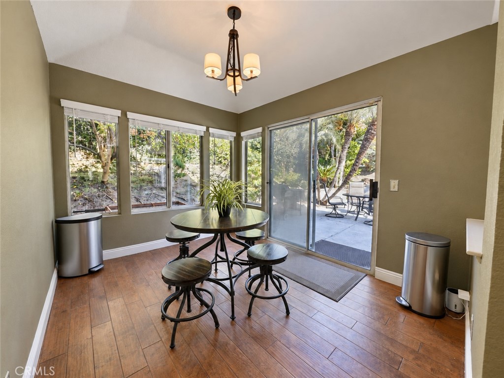 Breakfast nook in kitchen with view of Family Room that flows out to the back patio - 25652 Nottingham Court, Laguna Hills CA 92653 - photo 8