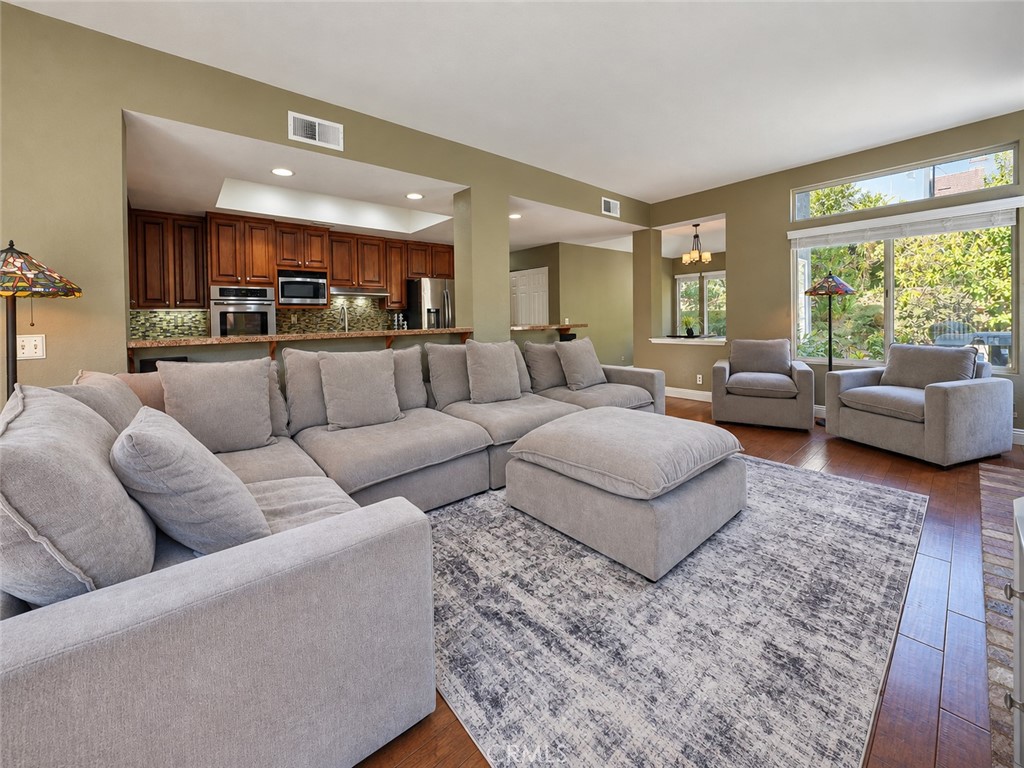 The expansive family room opens up to a spacious rear patio with luxury spa - 25652 Nottingham Court, Laguna Hills CA 92653 - photo 12