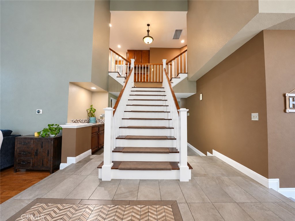 As you walk through the double doors into the entry way you will see this majestic staircase leading you up to the secon - 25652 Nottingham Court, Laguna Hills CA 92653 - photo 17